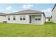 The backyard features a well-maintained lawn and a covered patio, ideal for outdoor entertaining and relaxation at 467 Sun Chaser Dr, Nokomis, FL 34275
