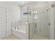 Modern bathroom with glass-enclosed shower, soaking tub and stylish fixtures at 467 Sun Chaser Dr, Nokomis, FL 34275