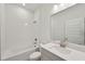 Bright bathroom featuring a tub/shower combo, stylish vanity, and contemporary finishes at 467 Sun Chaser Dr, Nokomis, FL 34275