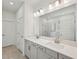 Luxurious bathroom with double vanity, quartz counters, framed mirror, and a glass-enclosed shower at 467 Sun Chaser Dr, Nokomis, FL 34275
