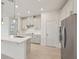 Modern kitchen with stainless steel appliances, white cabinets, and quartz countertops at 467 Sun Chaser Dr, Nokomis, FL 34275