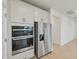 Modern stainless steel appliances, including refrigerator and built-in oven at 467 Sun Chaser Dr, Nokomis, FL 34275