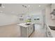 Open-concept kitchen featuring island, stainless dishwasher, and outdoor views at 467 Sun Chaser Dr, Nokomis, FL 34275