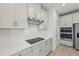 Close-up of the modern kitchen features, including the cooktop and range hood at 467 Sun Chaser Dr, Nokomis, FL 34275