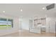 Open-concept living space with modern kitchen, island, and large windows with beautiful views at 467 Sun Chaser Dr, Nokomis, FL 34275