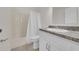 This bathroom features white vanity with gray countertop, shower, and neutral walls at 1616 39Th Avenue E Dr, Ellenton, FL 34222