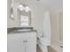 This bathroom features white vanity with gray countertop, shower, and neutral walls at 1616 39Th Avenue E Dr, Ellenton, FL 34222