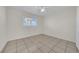 This bedroom features tile flooring, neutral walls, and a window with bright sunlight at 1616 39Th Avenue E Dr, Ellenton, FL 34222