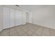 This bedroom features tile flooring, neutral walls, and a closet with doors at 1616 39Th Avenue E Dr, Ellenton, FL 34222