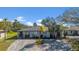 Charming single-story home featuring a well-maintained lawn and a paved driveway, accented by mature palm trees at 1616 39Th Avenue E Dr, Ellenton, FL 34222