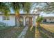 Inviting front entrance with a brick walkway, stone accents, and a mature palm tree at 1616 39Th Avenue E Dr, Ellenton, FL 34222