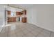 Open-concept kitchen featuring wooden cabinets, white appliances, and tile backsplash with a window view at 1616 39Th Avenue E Dr, Ellenton, FL 34222