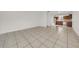 Spacious living room with neutral tile flooring, and natural light filtering through the windows at 1616 39Th Avenue E Dr, Ellenton, FL 34222