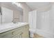 Bright bathroom featuring a tile floor, single sink vanity, and shower-tub combination with a white shower curtain at 1618 39Th Avenue E Dr, Ellenton, FL 34222