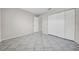 Well-lit bedroom featuring tile flooring, closet, and neutral paint providing a bright and spacious atmosphere at 1618 39Th Avenue E Dr, Ellenton, FL 34222