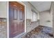 Inviting front entrance featuring a brown door, brick accents, and a covered porch at 1618 39Th Avenue E Dr, Ellenton, FL 34222