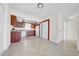 Spacious kitchen with dark wood cabinets, white appliances, and tile flooring at 1618 39Th Avenue E Dr, Ellenton, FL 34222