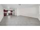 Bright living room featuring modern tile flooring, neutral walls, and kitchen access at 1618 39Th Avenue E Dr, Ellenton, FL 34222