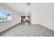 Bright living room showcasing modern tile flooring, neutral walls, and kitchen access at 1618 39Th Avenue E Dr, Ellenton, FL 34222