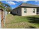 Spacious backyard with well-maintained lawn and a sturdy fence, offering privacy and room to play at 23149 Hammond Ave, Port Charlotte, FL 33954
