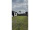 Large backyard with green grass and full fence offering plenty of space for outdoor activities and enjoyment at 23149 Hammond Ave, Port Charlotte, FL 33954