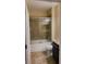 Bathroom showcasing a tiled shower with sliding glass door, toilet, and a vanity with dark wood cabinets at 23149 Hammond Ave, Port Charlotte, FL 33954