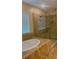 Spa-like bathroom featuring a soaking tub, a separate glass-enclosed shower, and stylish tile work at 23149 Hammond Ave, Port Charlotte, FL 33954