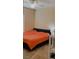 Bedroom featuring a large bed with orange bedding and a ceiling fan at 23149 Hammond Ave, Port Charlotte, FL 33954