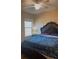 Bedroom showcasing ceiling fan, window, and ornate wooden bedframe with matching side table at 23149 Hammond Ave, Port Charlotte, FL 33954
