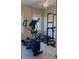 Exercise room including elliptical machine, bench and pull-up equipment and windows for natural light at 23149 Hammond Ave, Port Charlotte, FL 33954