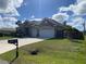 Inviting single Gathering home with a two-car garage, a well-kept lawn, and a traditional mailbox at 23149 Hammond Ave, Port Charlotte, FL 33954