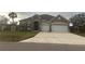 Charming single-Gathering home showcasing a stone facade, a two-car garage, and a well-maintained lawn at 23149 Hammond Ave, Port Charlotte, FL 33954