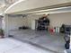 Open garage with storage shelves and water heater, providing ample space for vehicles and tools at 23149 Hammond Ave, Port Charlotte, FL 33954