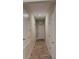 Long hallway with tiled flooring and doors on either side leading to various rooms at 23149 Hammond Ave, Port Charlotte, FL 33954