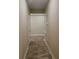 Narrow hallway with tiled flooring connecting different areas of the house at 23149 Hammond Ave, Port Charlotte, FL 33954