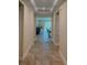 Hallway that leads to the living room and kitchen area, featuring tile flooring and neutral paint at 23149 Hammond Ave, Port Charlotte, FL 33954