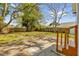 Large backyard featuring a wood fence, mature trees, and a concrete patio at 3445 40Th N St, St Petersburg, FL 33713