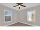 Bright bedroom featuring a ceiling fan and two windows providing plenty of natural light at 3445 40Th N St, St Petersburg, FL 33713