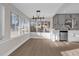 Dining room featuring hardwood floors and a modern chandelier, open to the kitchen at 3445 40Th N St, St Petersburg, FL 33713