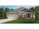 Charming single-story home with a well-maintained lawn, attached garage, and neutral color palette at 6622 Tortoise Trl, Parrish, FL 34219