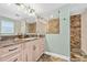 Bathroom featuring a granite countertop vanity, tile floors, a shower, and modern fixtures at 1690 Bayshore Dr, Englewood, FL 34223