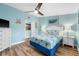 This bedroom is light blue with a queen-size bed at 1690 Bayshore Dr, Englewood, FL 34223