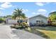 Charming single-story home with a well-manicured yard and beautiful landscaping at 1690 Bayshore Dr, Englewood, FL 34223