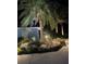 Professionally landscaped front yard featuring accent lighting and rock features at 1690 Bayshore Dr, Englewood, FL 34223