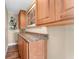 This kitchen area has wooden cabinets, granite countertops and hardwood floors at 1690 Bayshore Dr, Englewood, FL 34223