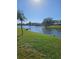 Scenic backyard with lush green grass and canal, offering a peaceful waterfront setting at 1706 S Lakeside Ct, Venice, FL 34293