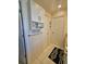 Bathroom view showcasing cabinets, decorative towel rack, and 'By The Sea' signage, creating a cozy, themed space at 1706 S Lakeside Ct, Venice, FL 34293