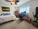 Cozy bedroom with a ceiling fan, a window with shutters, and nautical decor at 1706 S Lakeside Ct, Venice, FL 34293