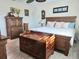 A bedroom with a wooden bed, matching furniture, and décor providing a cozy and well-furnished space at 1706 S Lakeside Ct, Venice, FL 34293