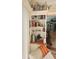 Built-in bookcase with coastal decorations and reading material near a comfortable chair at 1706 S Lakeside Ct, Venice, FL 34293